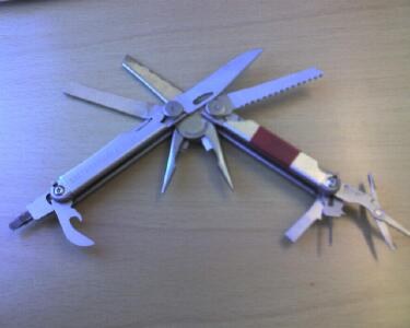 Legacy Leatherman Wave multitool with blades, pliers and other implements unfolded