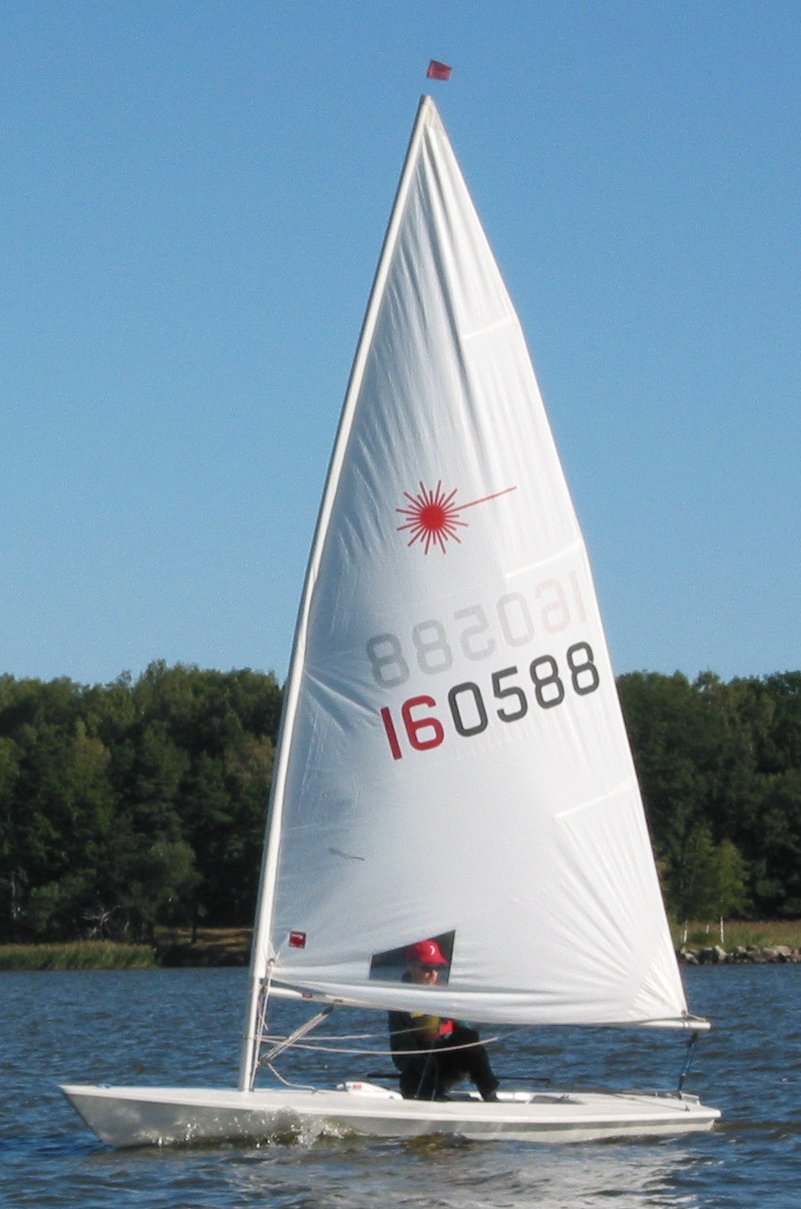 Laser (ILCA) sailing dinghy planing on flat water