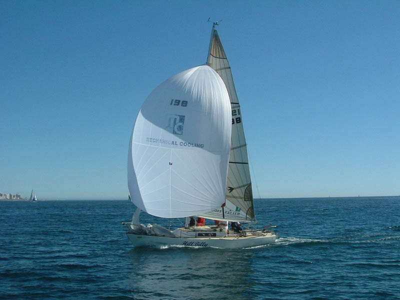 J/27 one-design racing sailboat flying a spinnaker