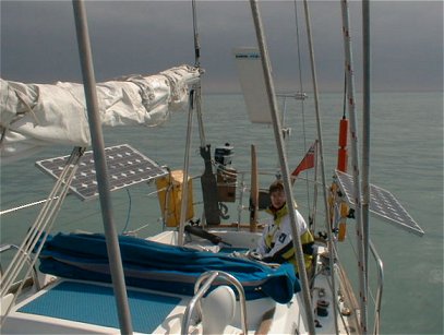 Solar panels mounted on the stern arch of a cruising sailboat underway at sea