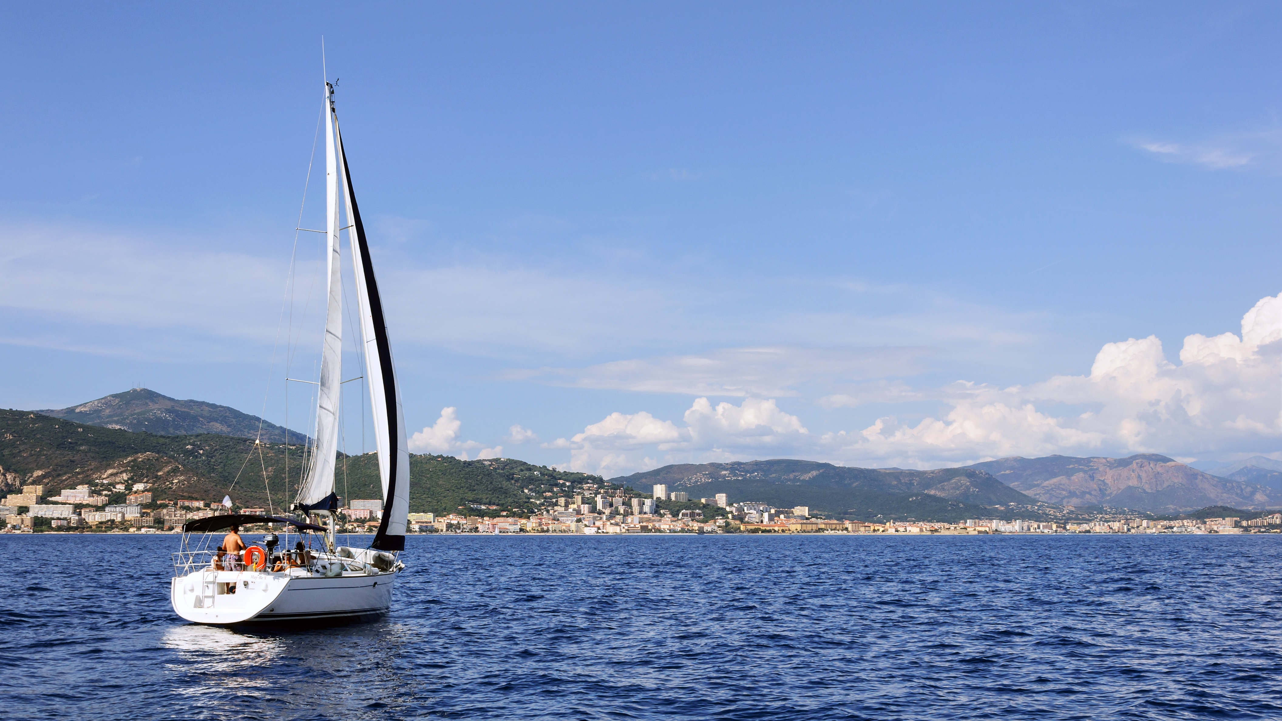 A satellite communications antenna mounted on a yacht with open ocean behind it